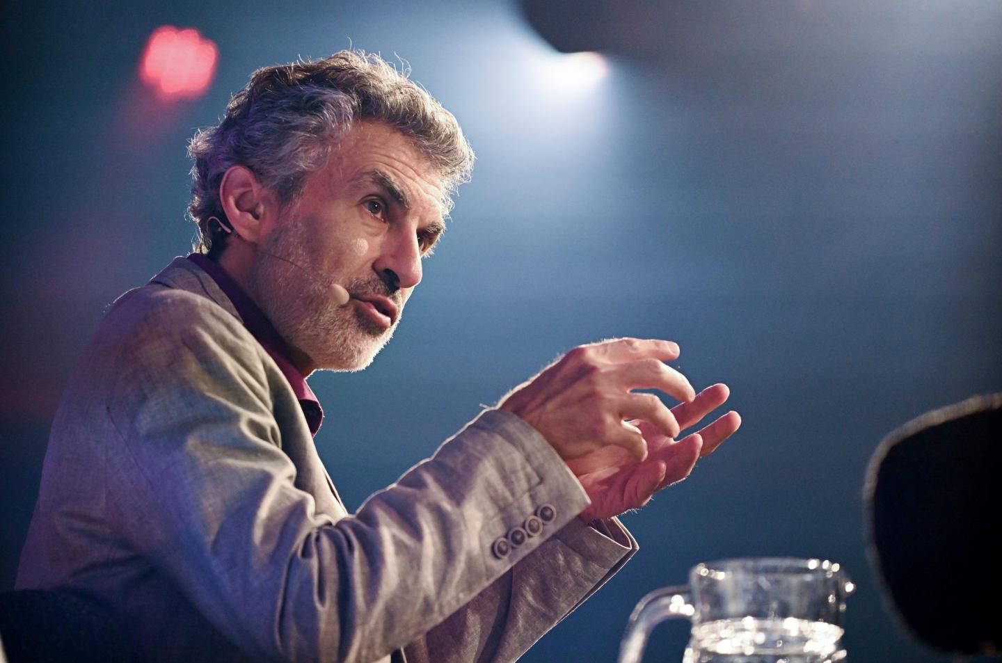 Yoshua Bengio on stage at an event