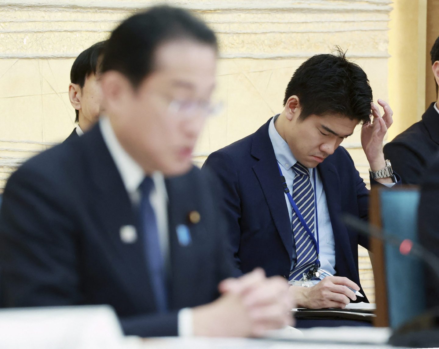 Shotaro Kishida, son of Japan's Prime Minister Fumio Kishida, sits behind his father at a meeting.