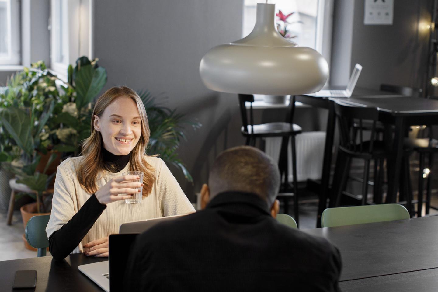 Woman talking in the office with male boss