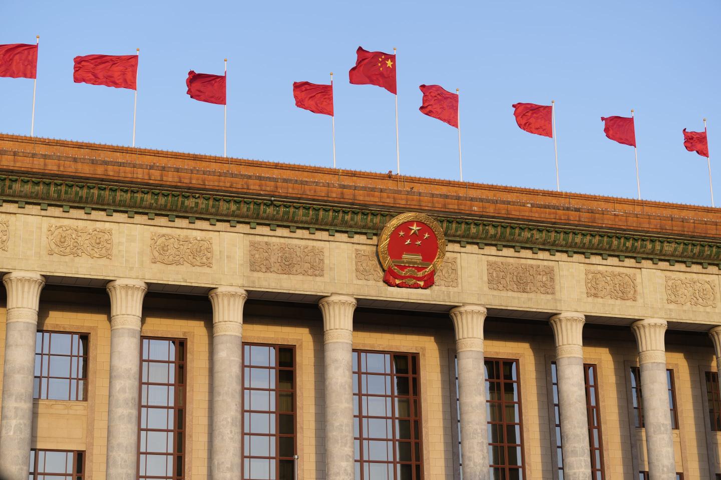 Chinese national flags flutter on the Great Hall of the People during the fifth plenary meeting of the first session of the 14th National People's Congress (NPC) on March 12, 2023 in Beijing.