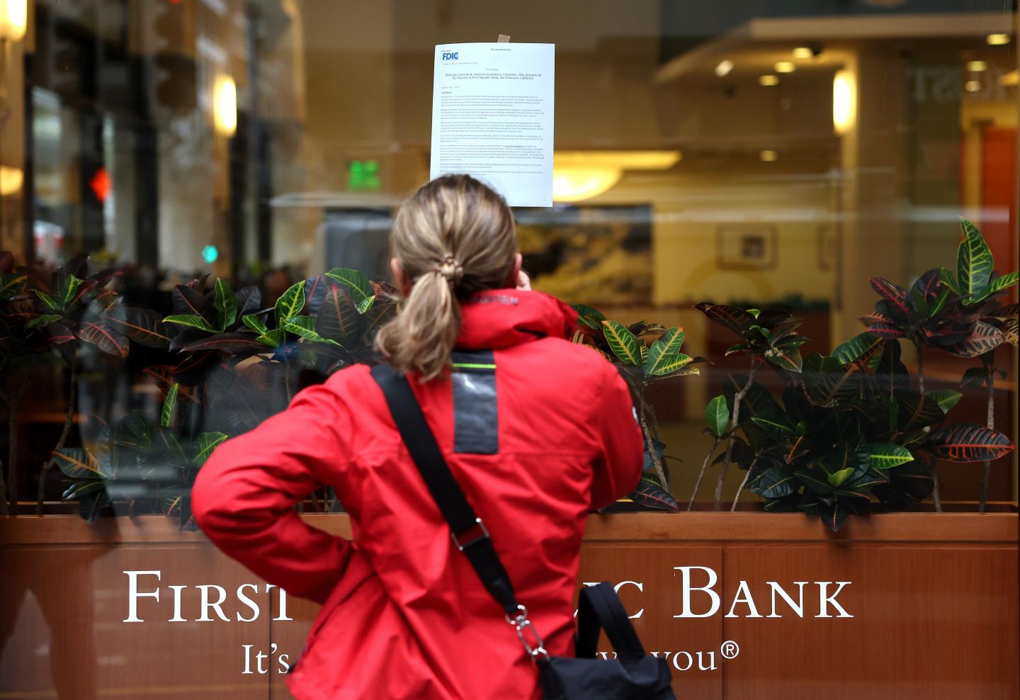 A woman reads an announcement in front of a First Republic Bank branch in San Francisco.