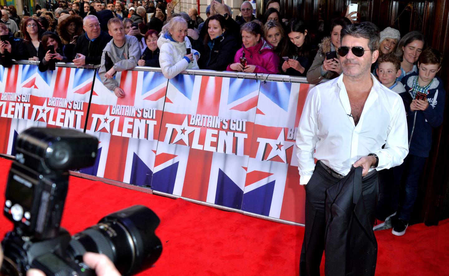 Simon Cowell posing for paparazzi