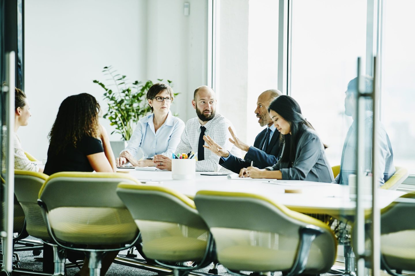 Mature businessman leading meeting in office conference room