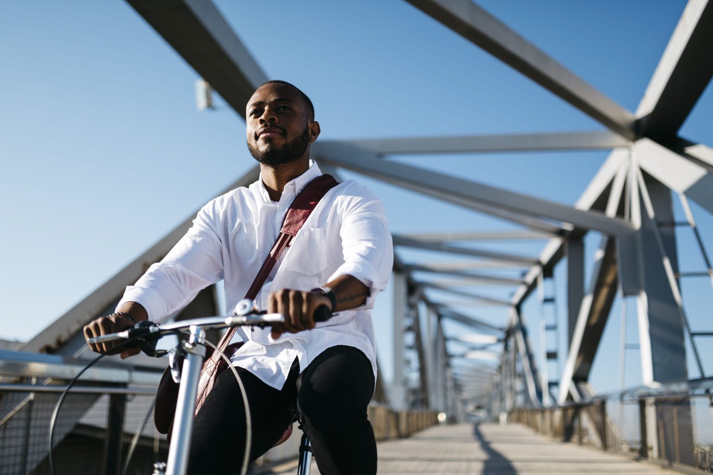 Man riding bicycle on a bridge