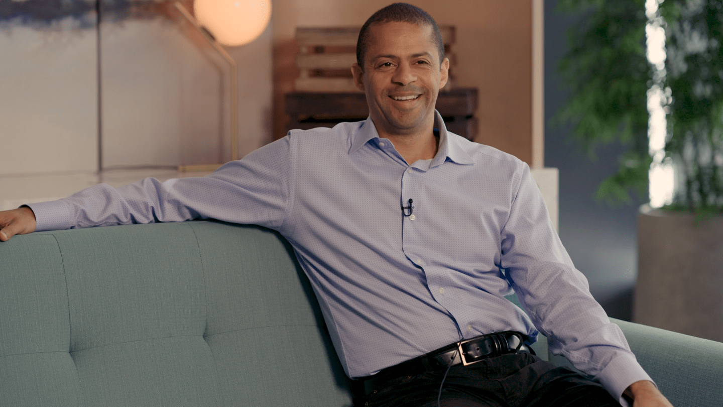 François Locoh-Donou, CEO of F5 sits on a chair in his living room