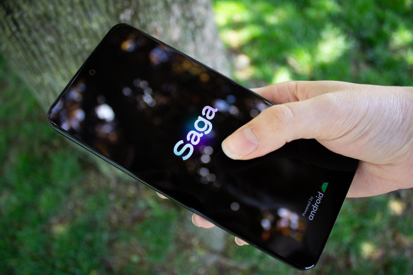Someone holds a Solana Saga smartphone.