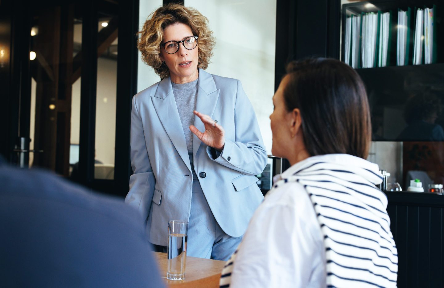 A woman looks concerned as she leads a business meeting.
