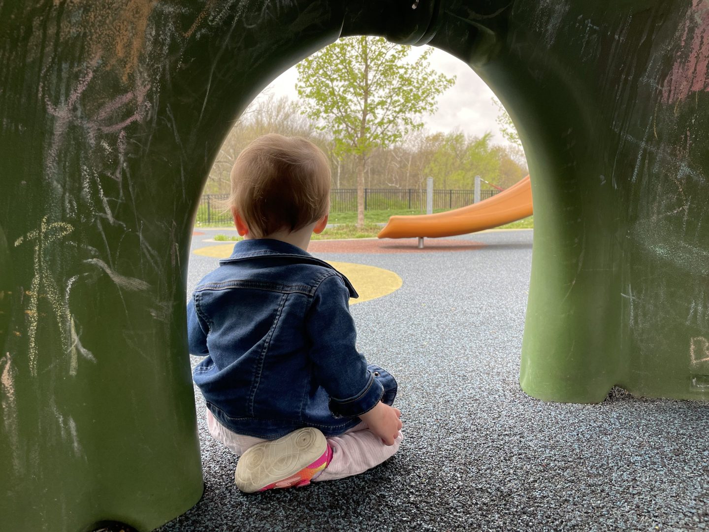 Photo of child sitting in a playground