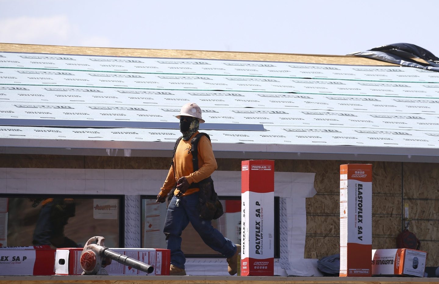 A construction worker continues building at a large housing development, April 21, 2020, in Phoenix. 