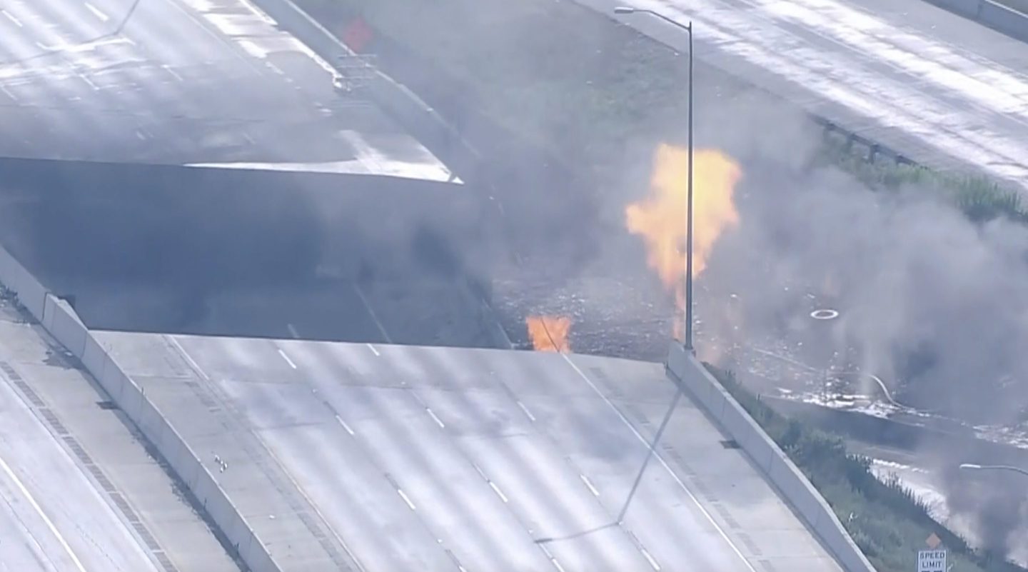 This screen grab from video provided by WPVI-TV/6ABC shows fire and smoke near the collapsed section of I-95 in Philadelphia on Sunday.