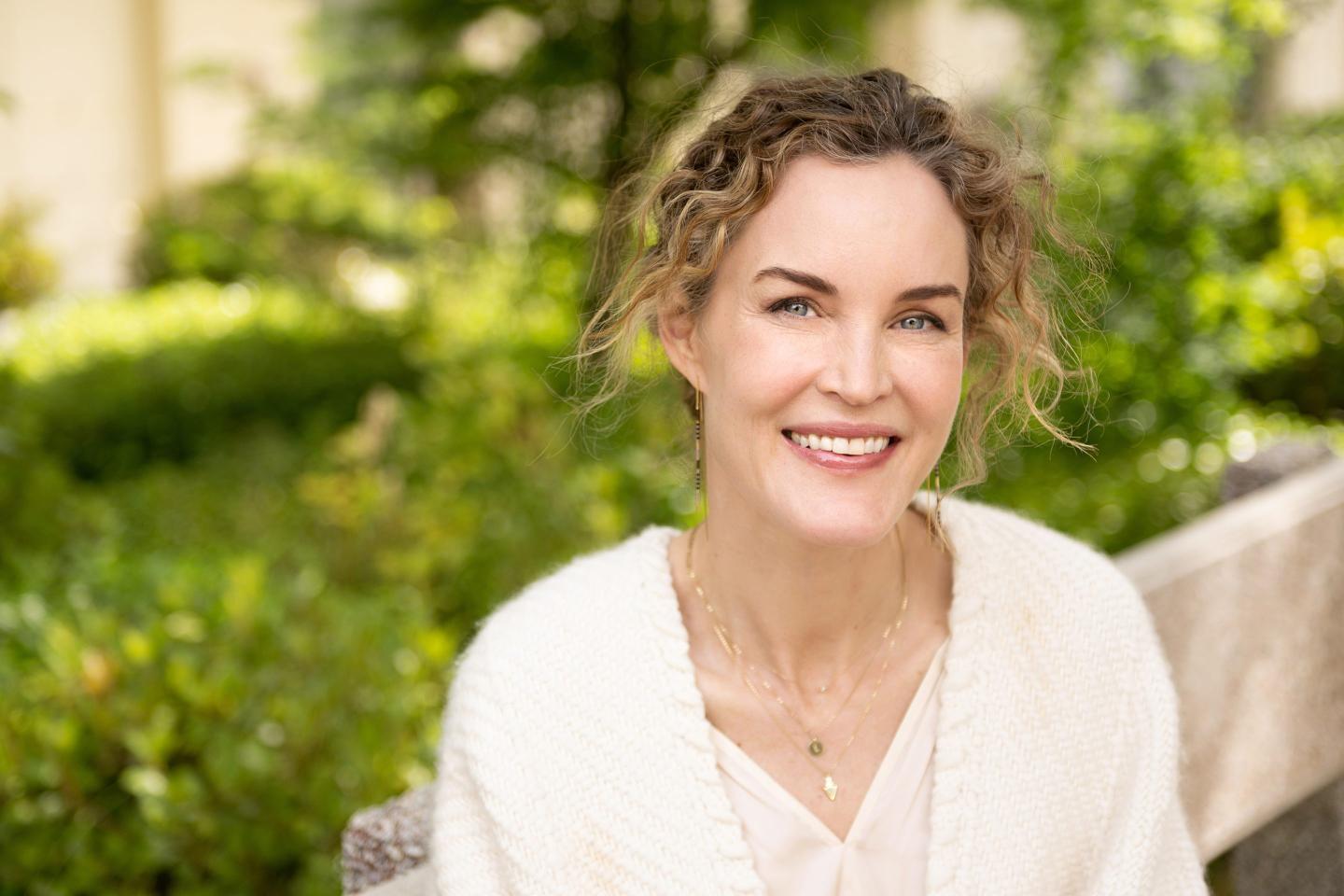woman with curly hair smiling