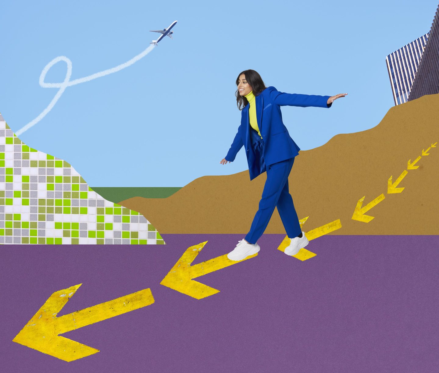 Smartly dressed business woman walking along a pathway of arrows