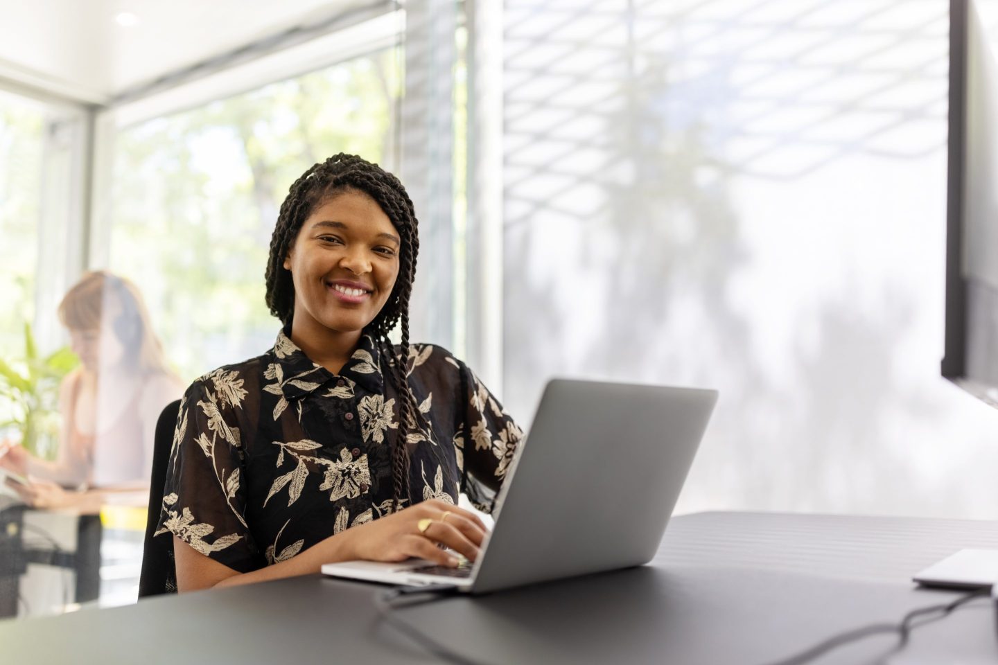 Smiling young woman sitting office desk