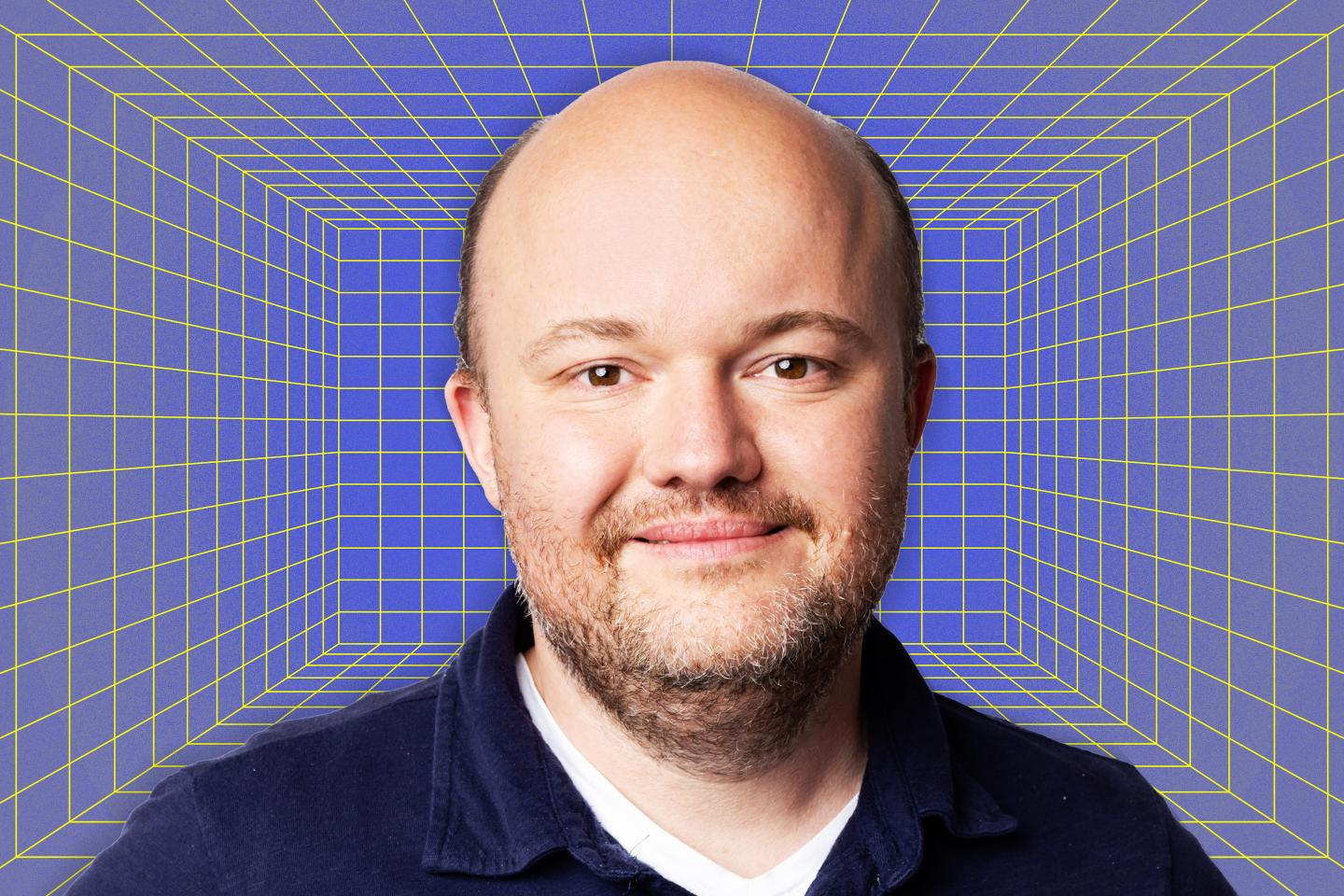 A headshot of Zac Townsend in front of a computer-themed background.