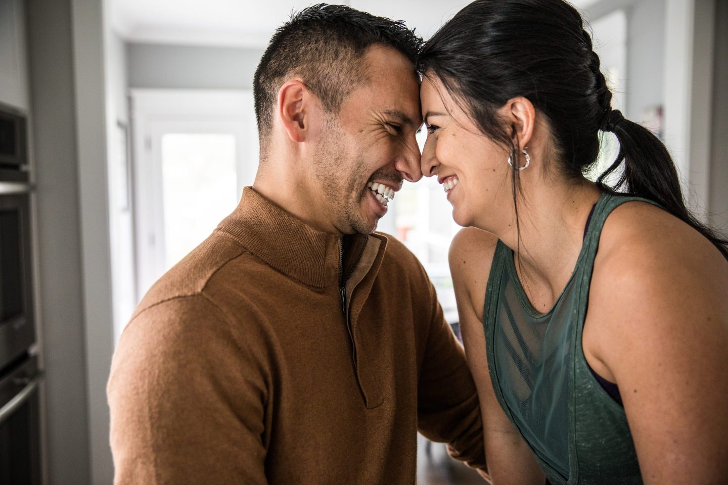 Husband and wife hugging in kitchen