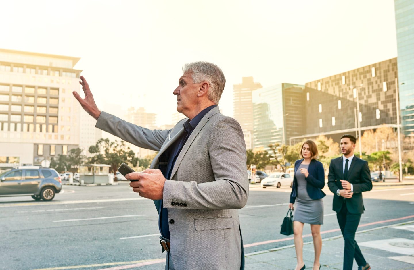 A businessman gesturing for a cab in the city