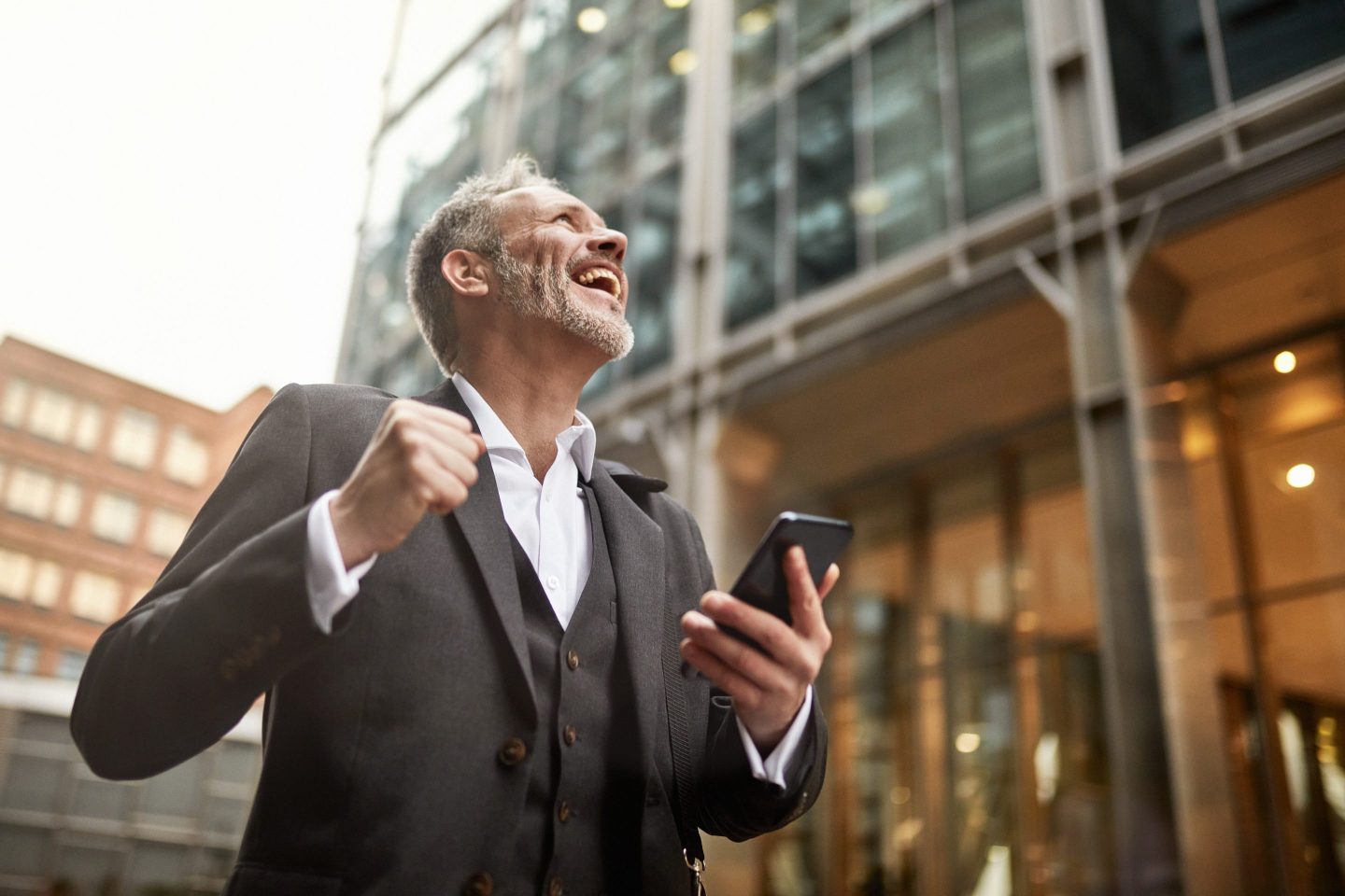 Ecstatic Businessman on Smart Phone