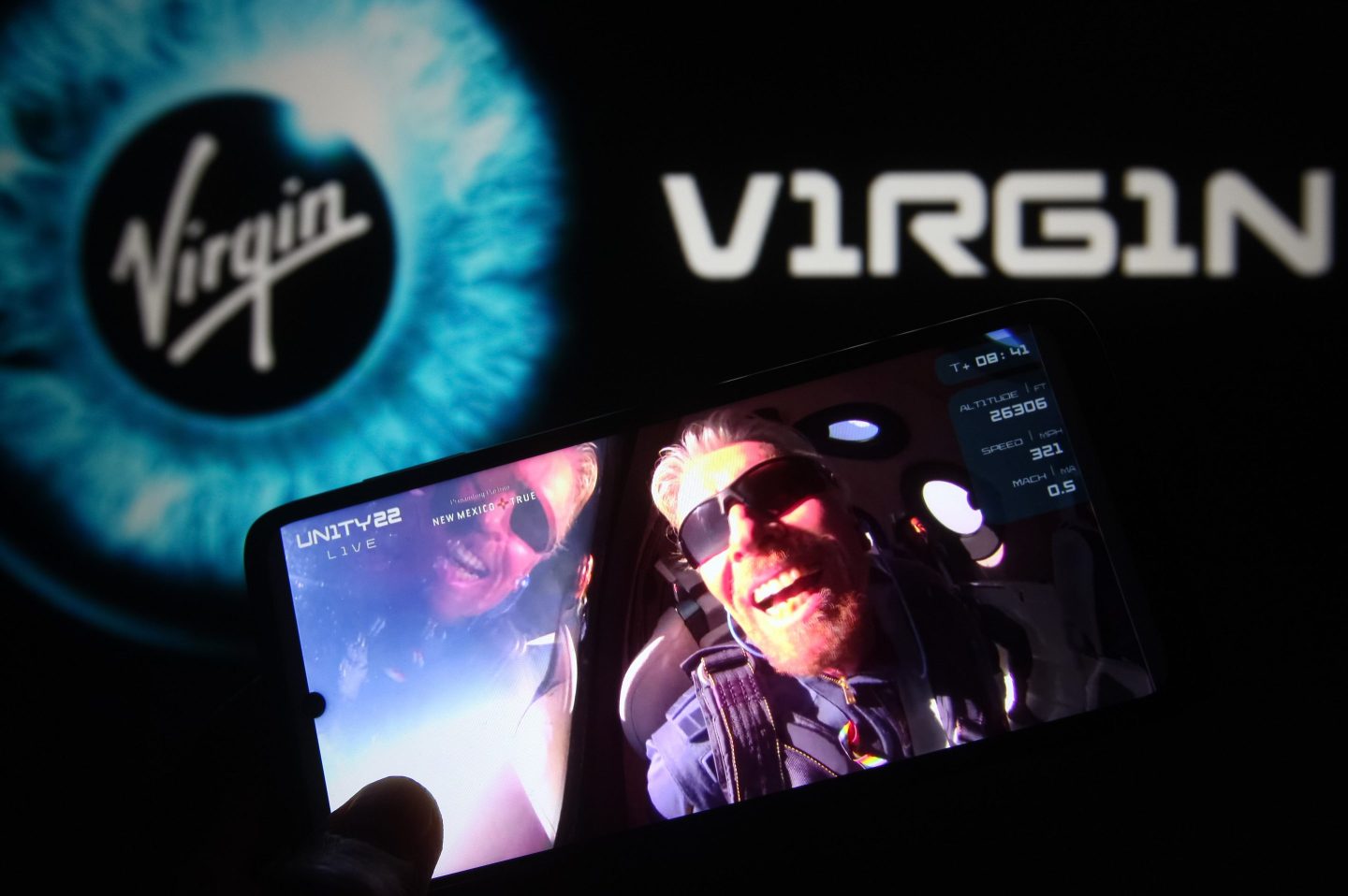 British billionaire Richard Branson is seen on a fragment of a Virgin Galactic Unity 22 Spaceflight Livestream Youtube video displayed on a smartphone