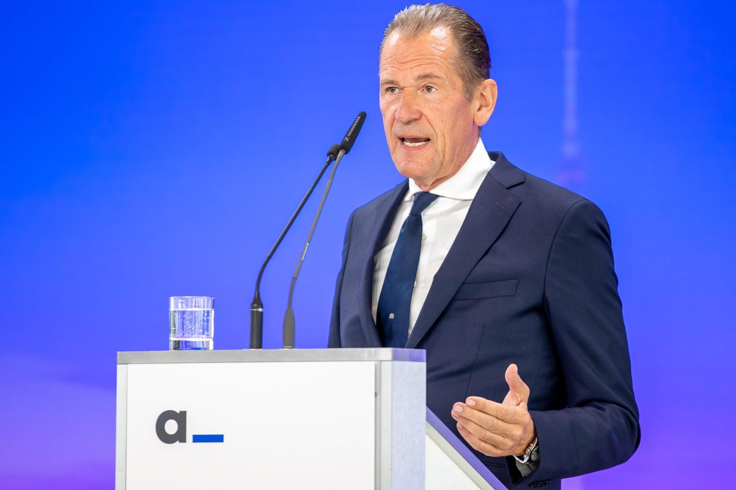 Mathias Dopfner standing behind a podium and speaking