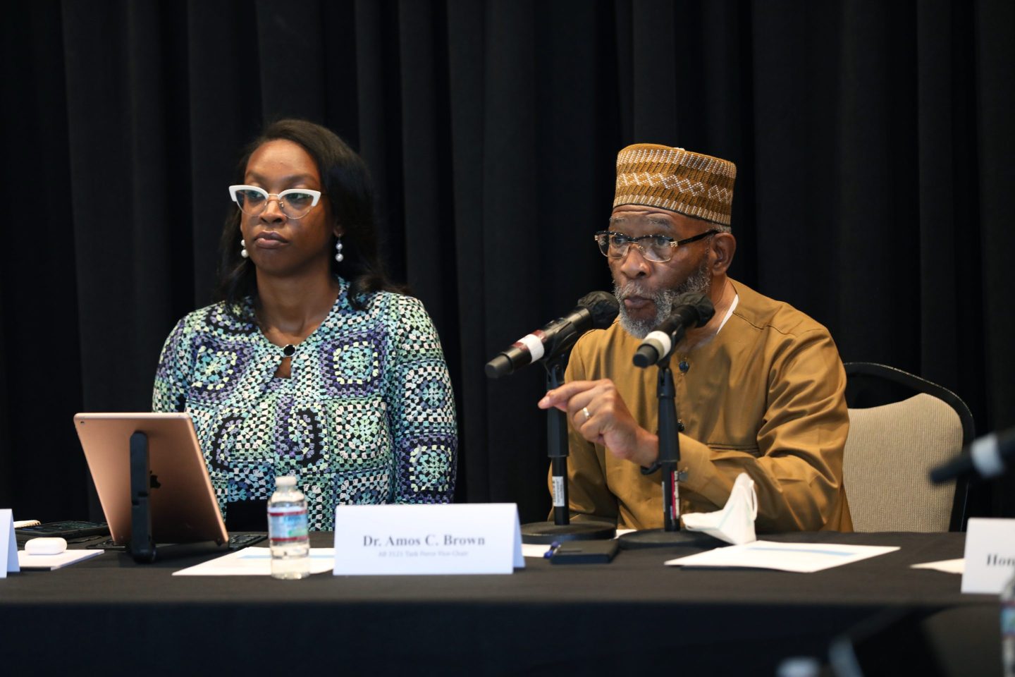 Kamilah Moore, chair of the California Reparations Task Force, left, and Dr. Amos C. Brown right, vice-chair. California Reparations Task Force listen to public input on reparations at the California Science Center in Los Angeles on Sept. 22, 2022.