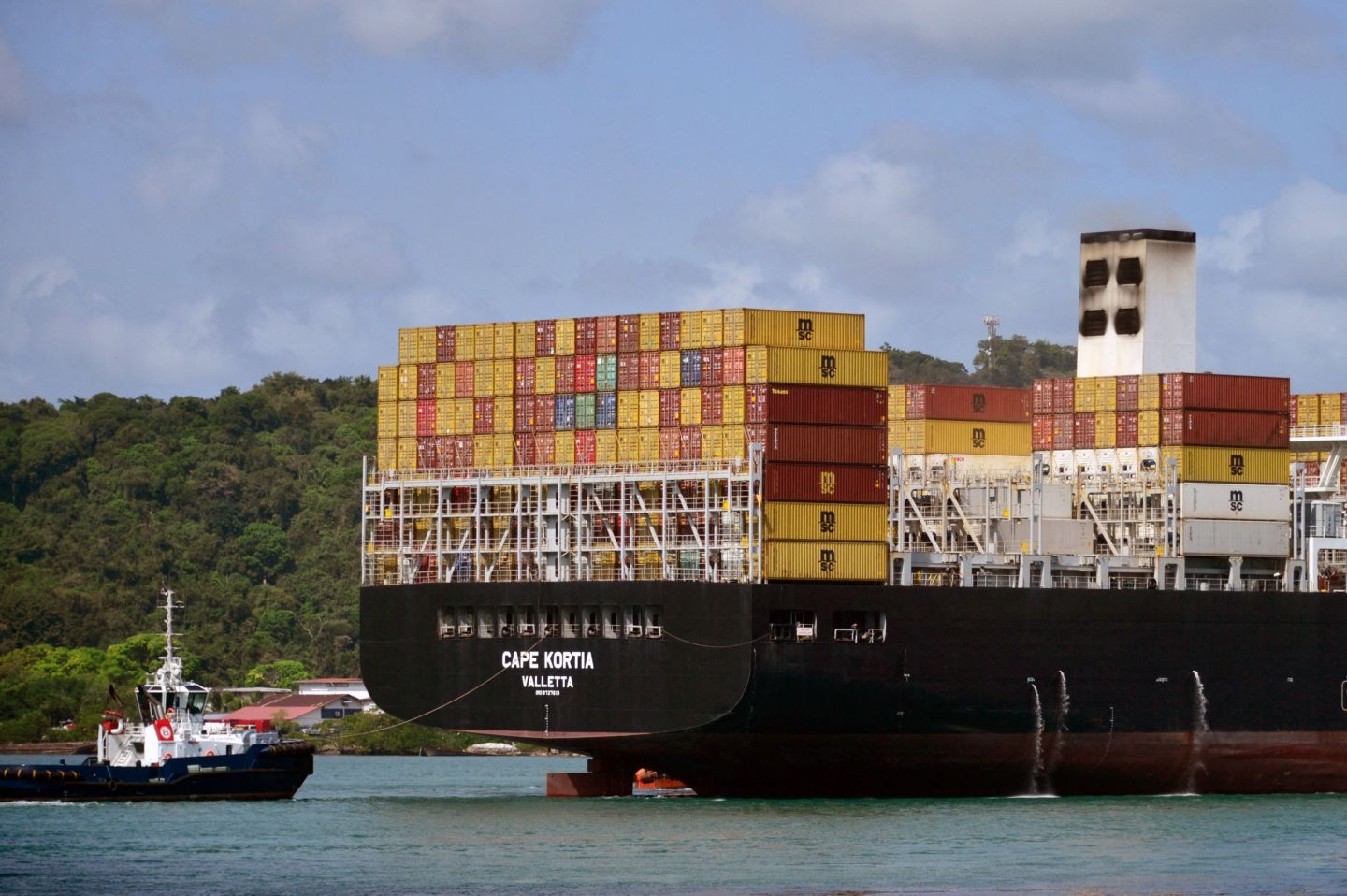 Tugboats pull the Malta-flagged Carpe Kortia container ship after an "outbreak of fire" in the engine room -which left no casualties- at the Panama canal, Panama, on January 30, 2023.