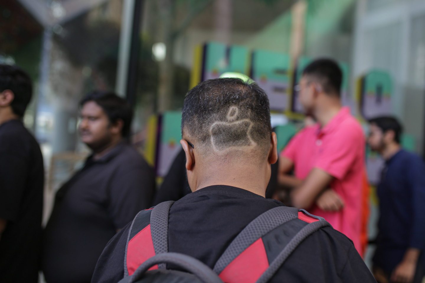 Shape of Apple Inc. logo on customers' head at new Apple store.