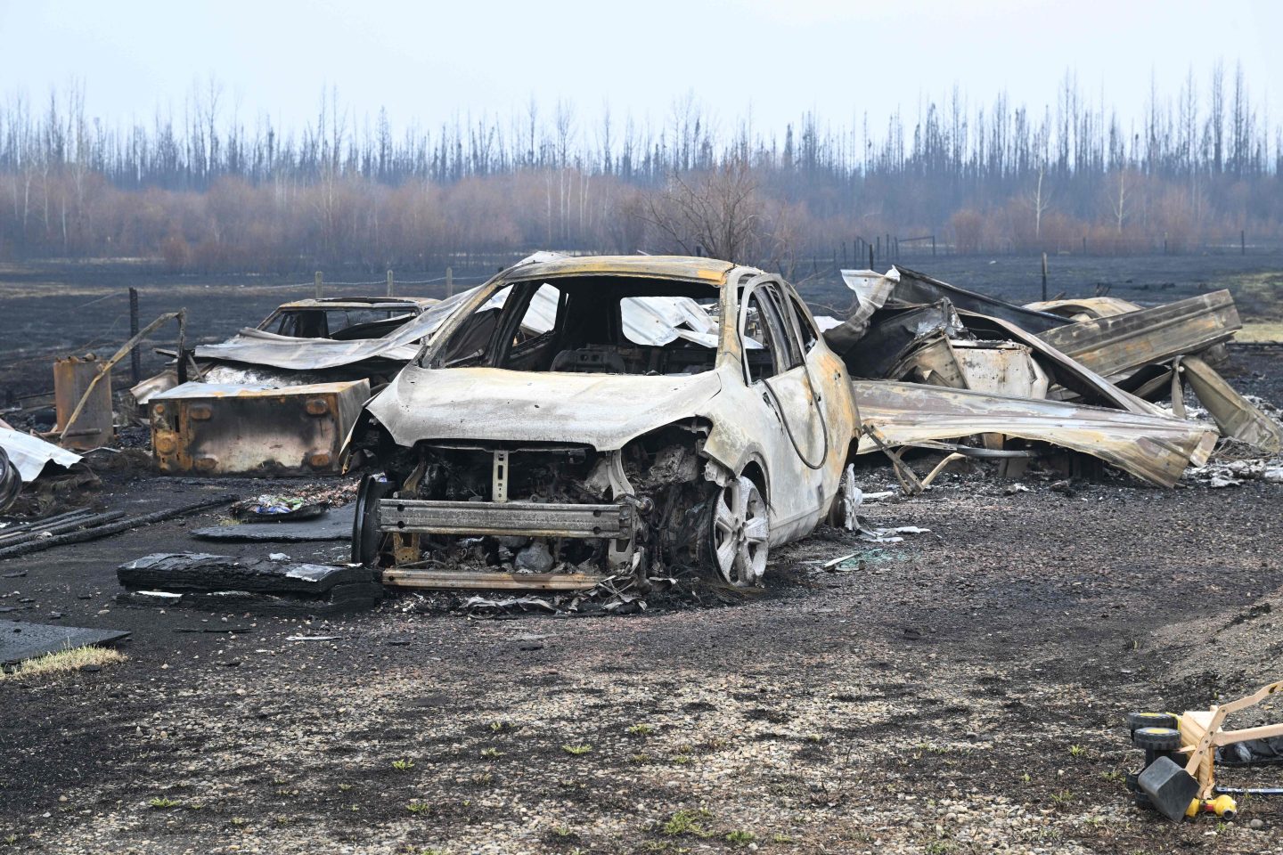 Damaged vehicles sit near the property of Adam Norris, in Drayton Valley, Alberta, Canada, on May 8, 2023. &#8211; Canada struggled on Monday to control wildfires that have forced thousands to flee, halted oil production and threaten to raze towns, with the western province of Alberta calling for federal help. (Photo by Walter Tychnowicz / AFP) (Photo by WALTER TYCHNOWICZ/AFP via Getty Images)