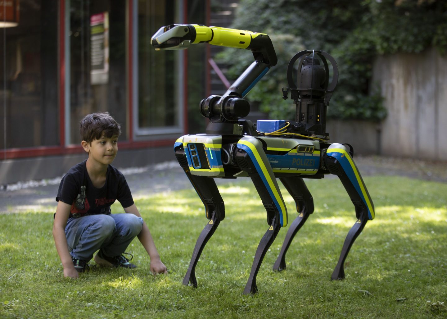 Boy observing a walking robot in Bonn, Germany