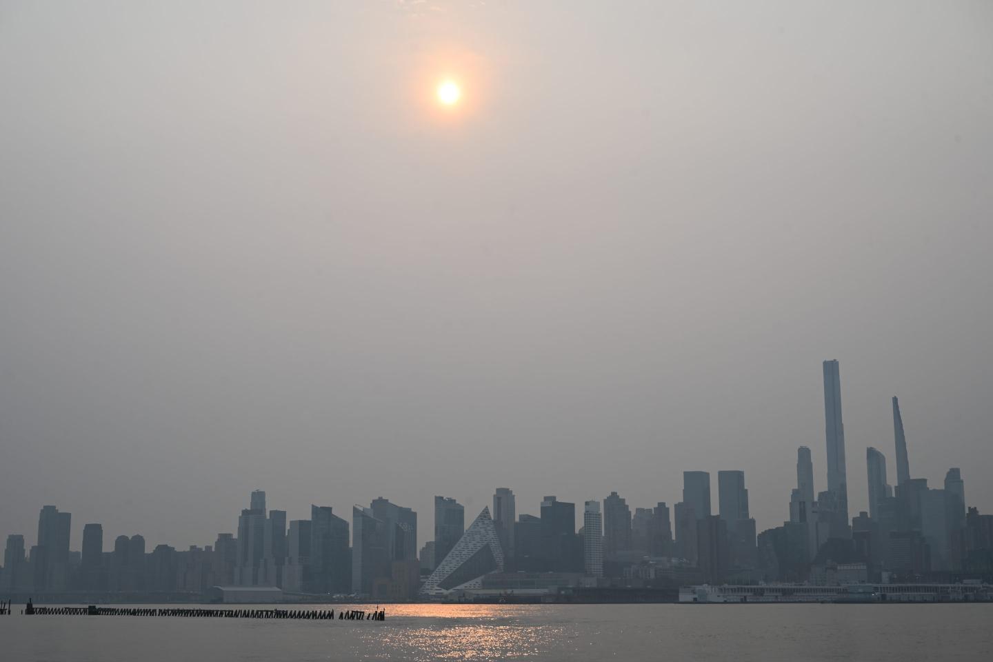 Canadian wildfires are bringing smoke-filled air and a hazy orange glow to the skies above New York City