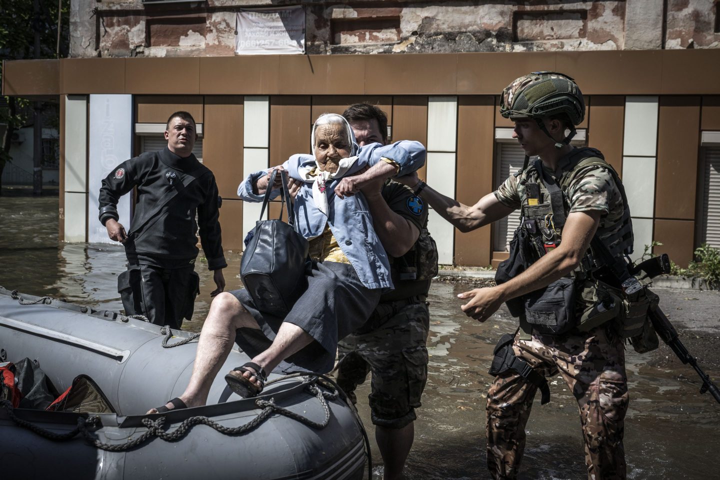 A Ukrainian senior woman is being evacuated by officers after the explosion at the Kakhovka hydropower plant that flooded houses and streets in Kherson, Ukraine on June 07, 2023.