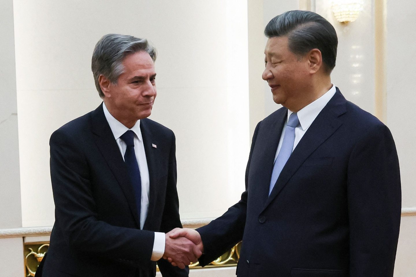 US Secretary of State Antony Blinken (L) shakes hands with China's President Xi Jinping