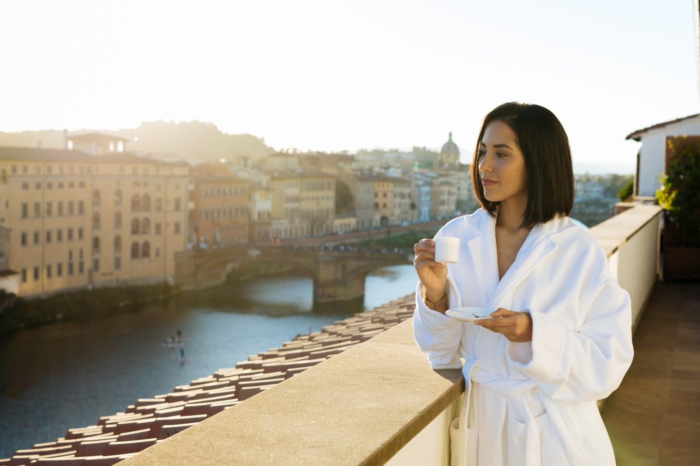 woman having coffee on balcony in florence