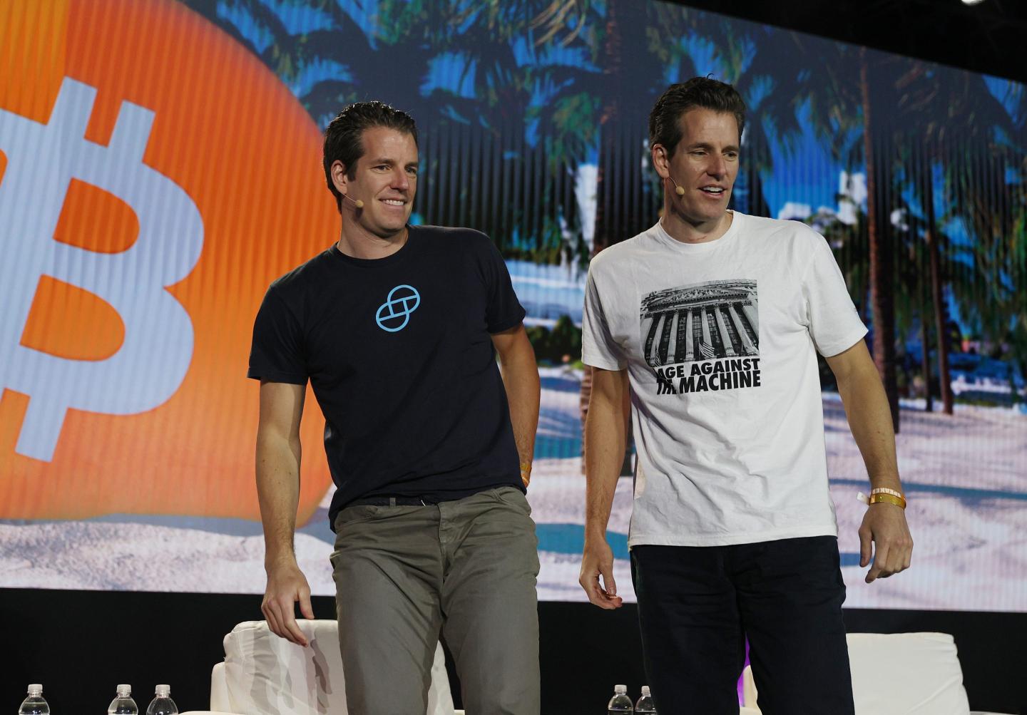 Tyler and Cameron Winklevoss, founders of the crypto exchange Gemini, speak on stage at the Bitcoin 2021 conference.