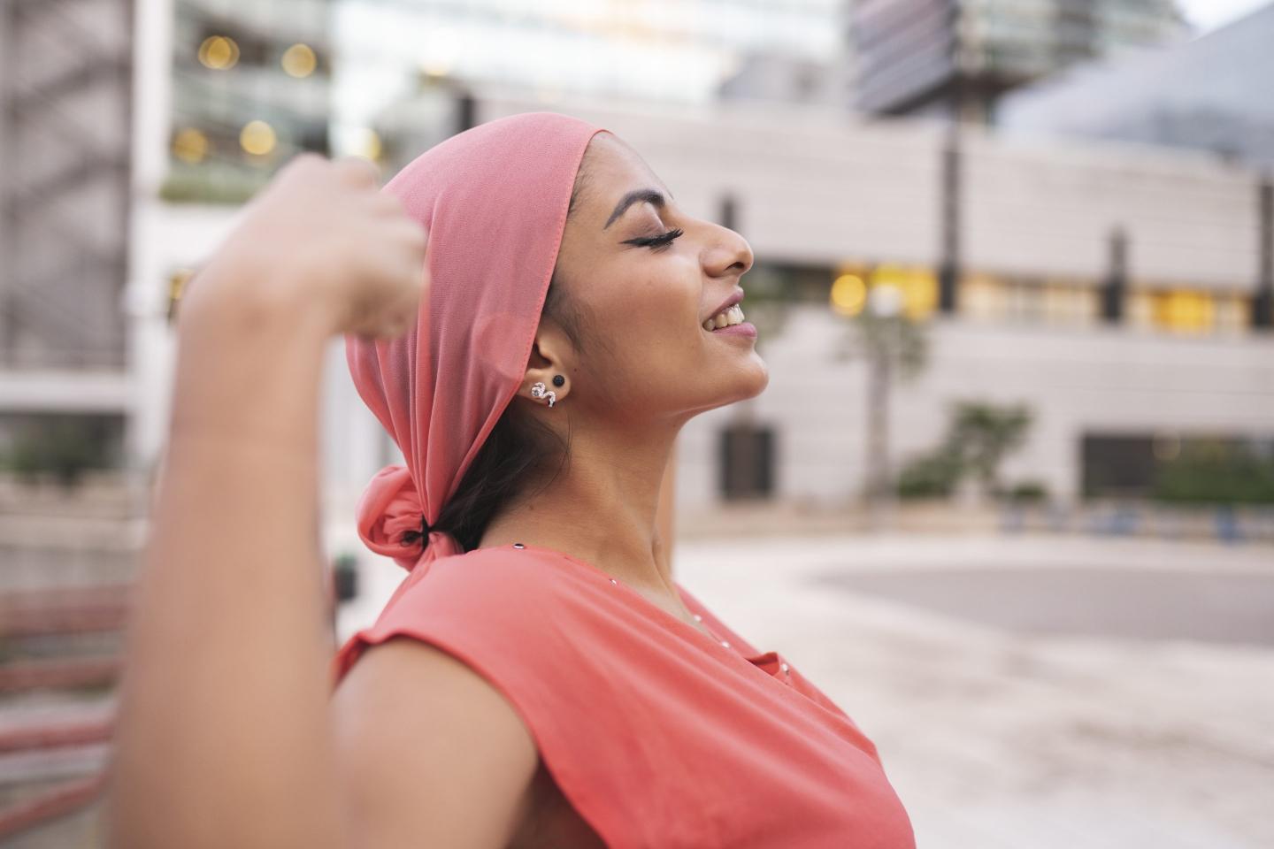Woman wearing a pink scarf