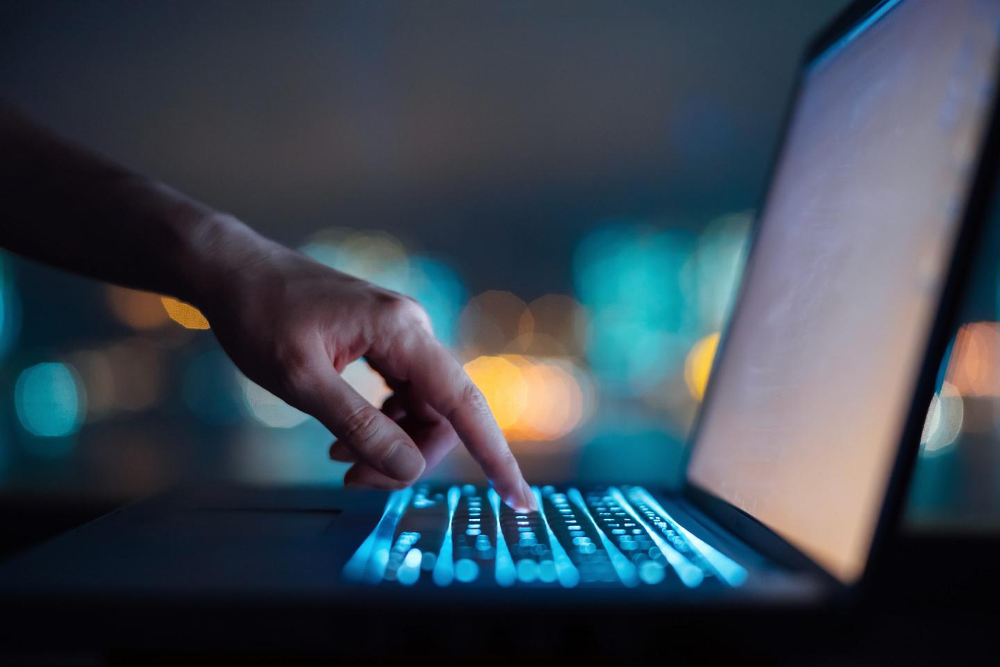 Close up of woman's hand typing on computer keyboard