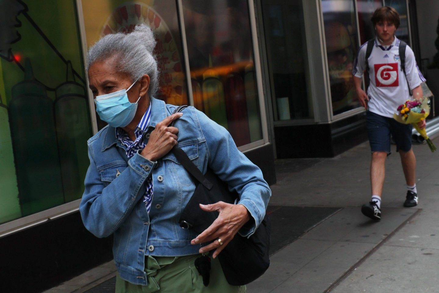 People wear masks amid hazy conditions due to smoke from the Canadian wildfires in Times Square on June 8, 2023 in New York City.