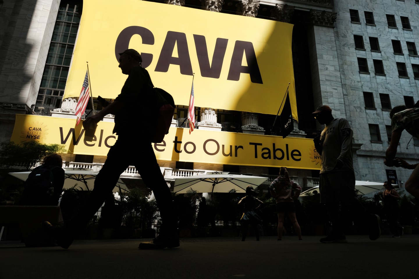 A banner for the Mediterranean restaurant chain Cava is displayed outside of the New York Stock Exchange as the company goes public on June 15, 2023 in New York City.