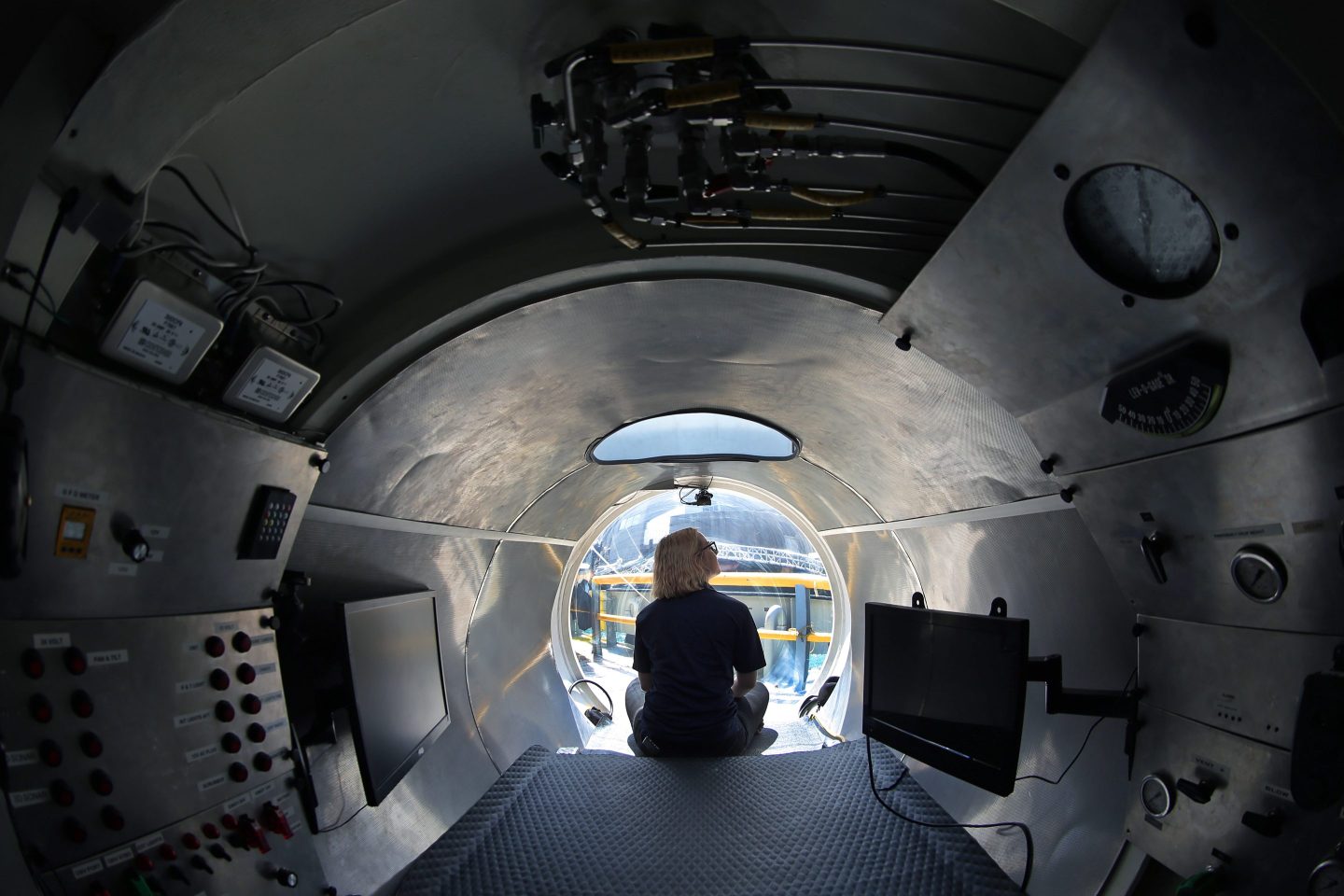 Isabel Johnson, sub pilot in training, sits by the glass bubble at the bow to show the view inside the Cyclops 1, a five-person sub that was used by OceanGate to capture detailed sonar images of the Andrea Doria shipwreck.