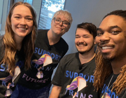 Photo of four smiling people