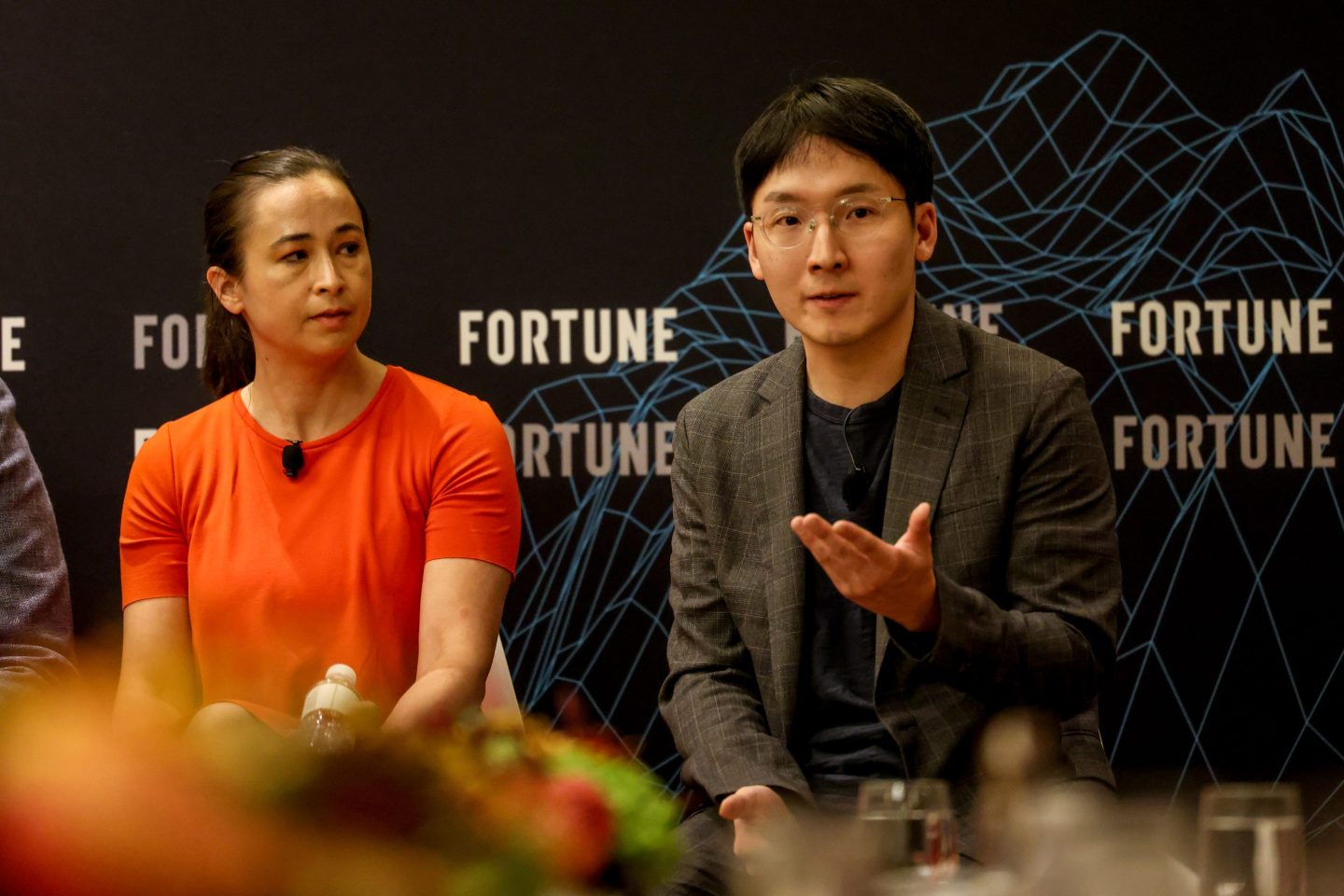 woman and man speaking onstage