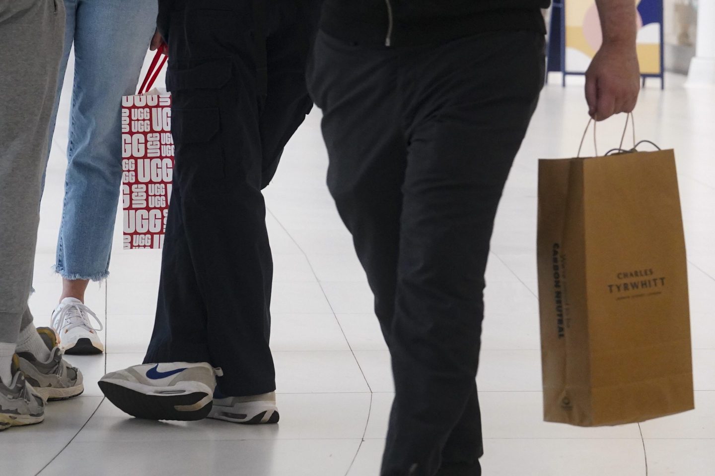 Shoppers hold their latest purchases while walking through the Oculus Center shopping mall, on June 6, 2023, in New York.
