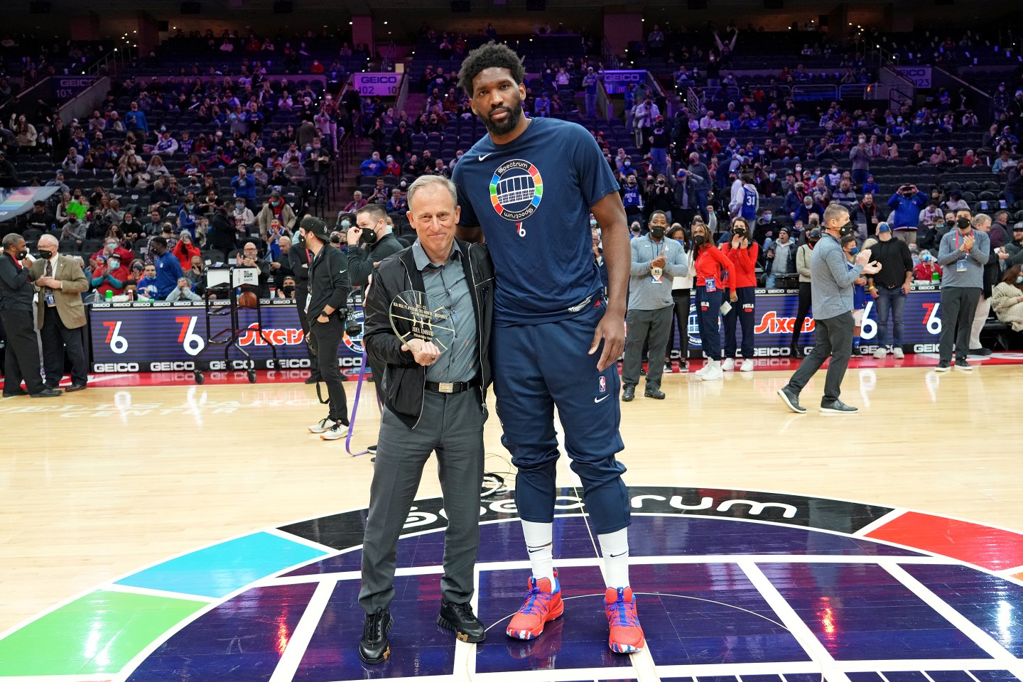 two men standing in the center of a basketball court