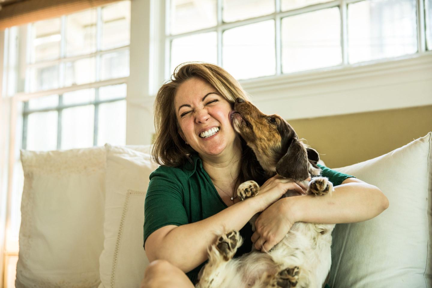 Woman cuddling her dog