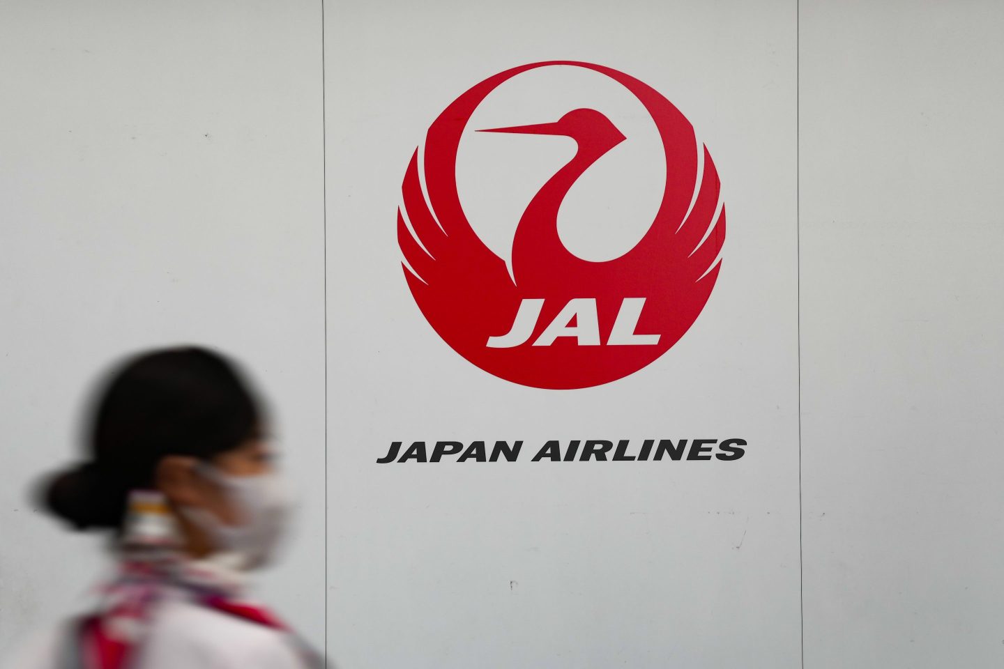 The Japan Airlines logo displayed inside a departure hall at Haneda Airport in Tokyo, on April 27, 2023.