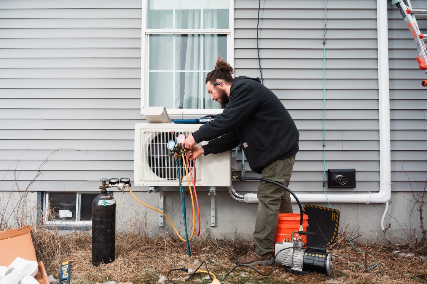 A technician installs an electric heat pump in Maine