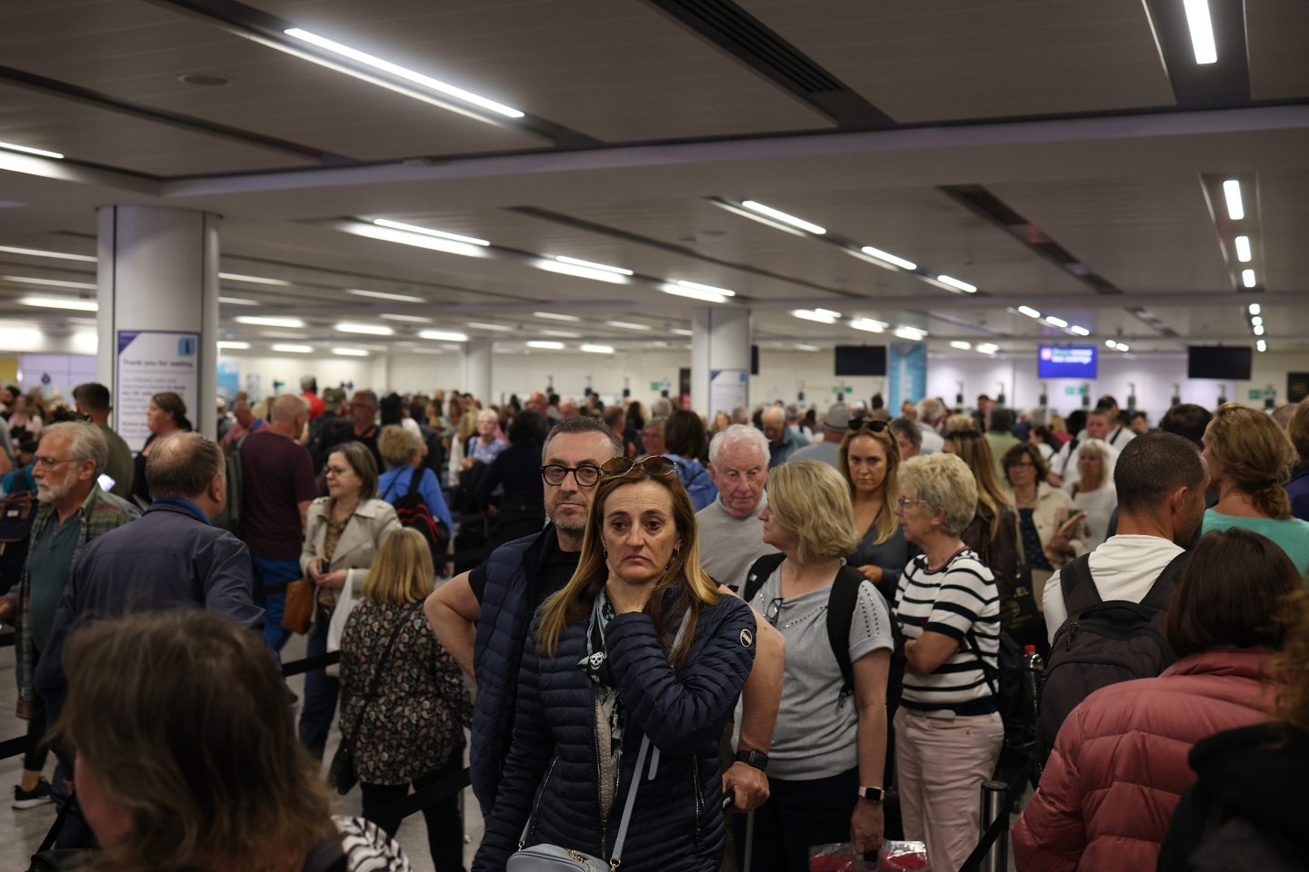 Passengers queue at Gatwick Airport as electronic passport gates fail