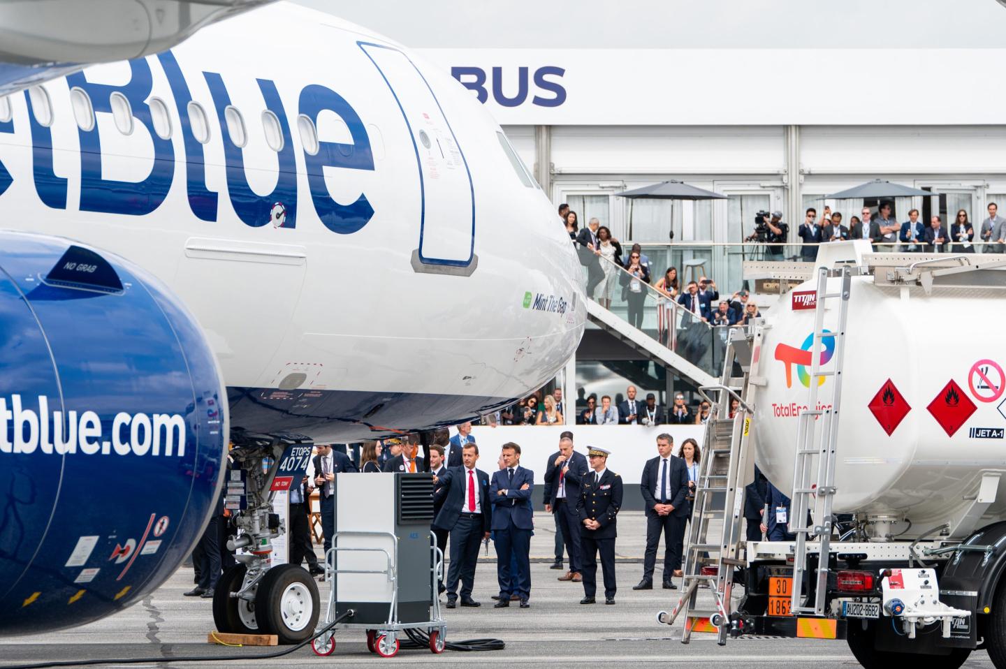 Emmanuel Macron, France's president, center, near a JetBlue Airways Corp. airliner during a tour of the Paris Air Show in Le Bourget, Paris, France, on June 19, 2023. 