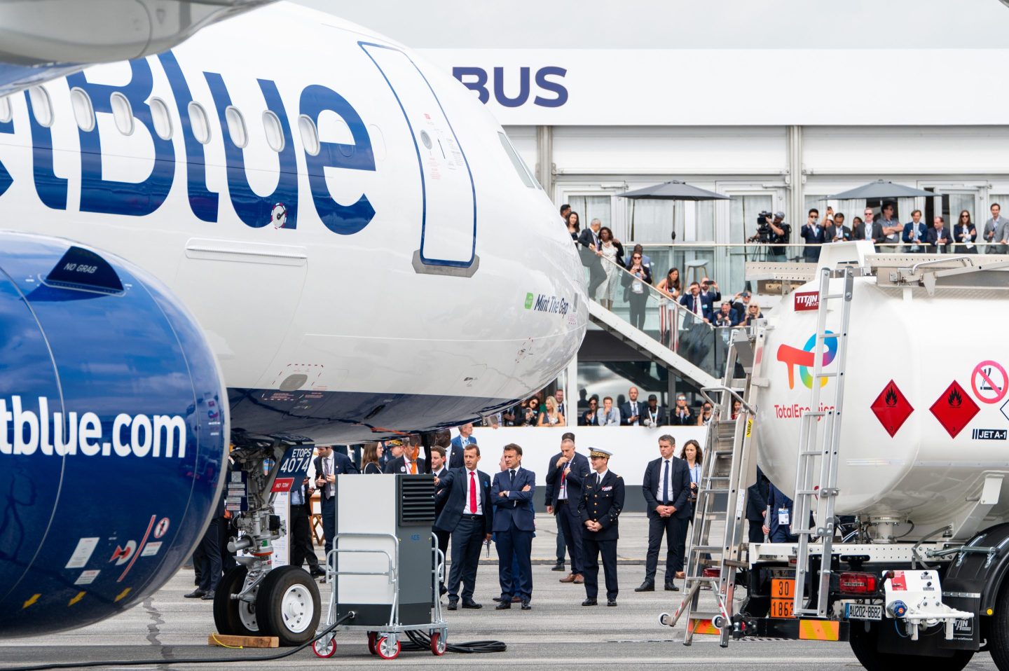Emmanuel Macron, France's president, center, near a JetBlue Airways Corp. airliner during a tour of the Paris Air Show in Le Bourget, Paris, France, on June 19, 2023.