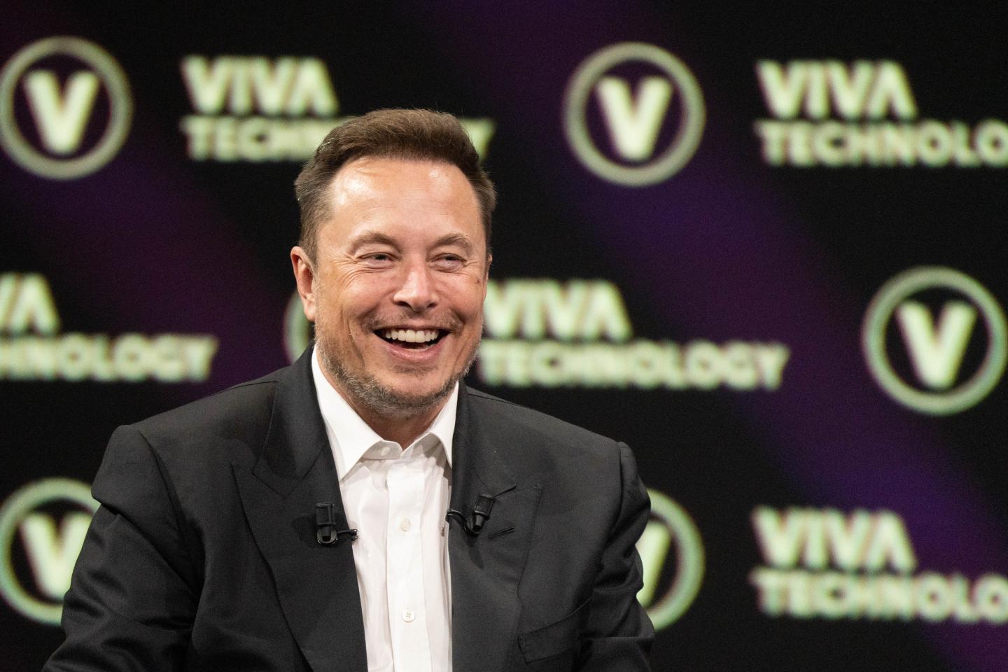 Elon Musk, CEO of Twitter and Tesla, speaks on stage at a conference in Paris.