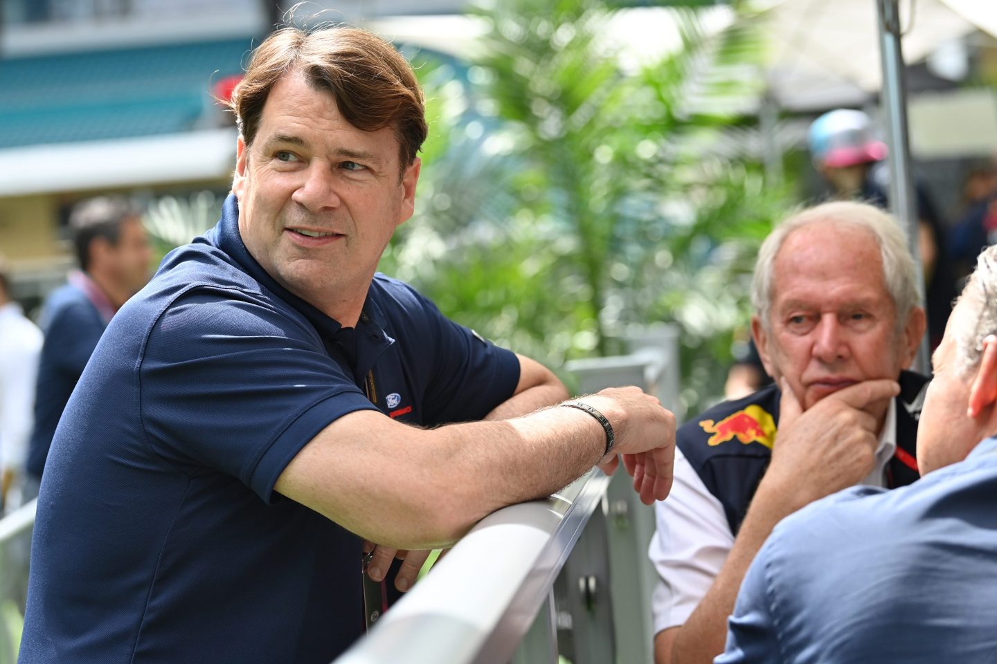 Ford CEO Jim Farley leans over a railing at the Miami F1 Grand Prix.